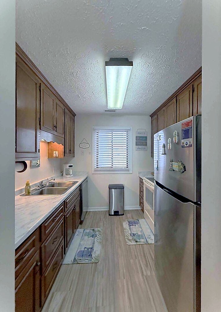 Galley kitchen with full-size appliances and ample cabinet storage